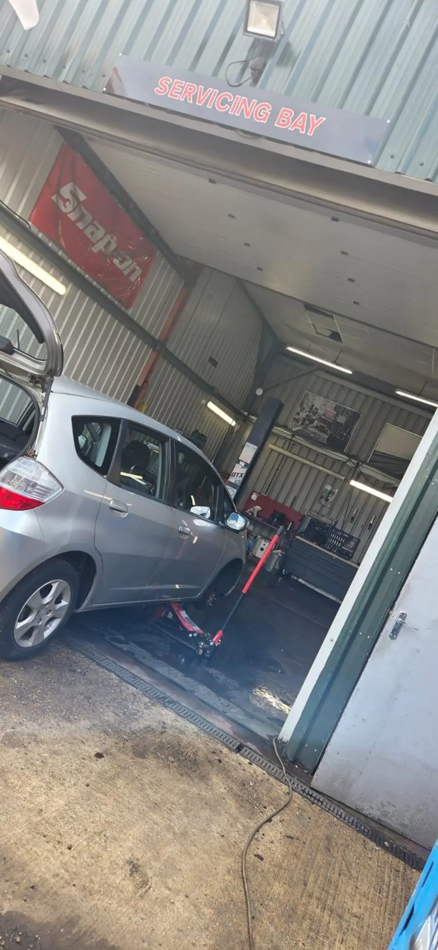 The servicing bay at Chertsey Tyres & Service Centre with a car inside