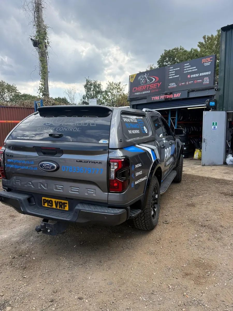 A pickup truck parked outside the Chertsey Tyres & Service Centre workshop units